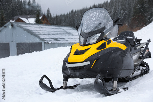 New stylish snowmobile parked outdoors. Winter recreation