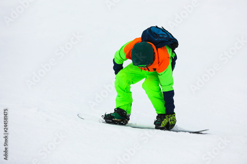 Snowboarder on slope at resort. Winter vacation