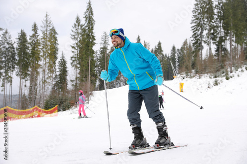 Male skier on slope at resort. Winter vacation