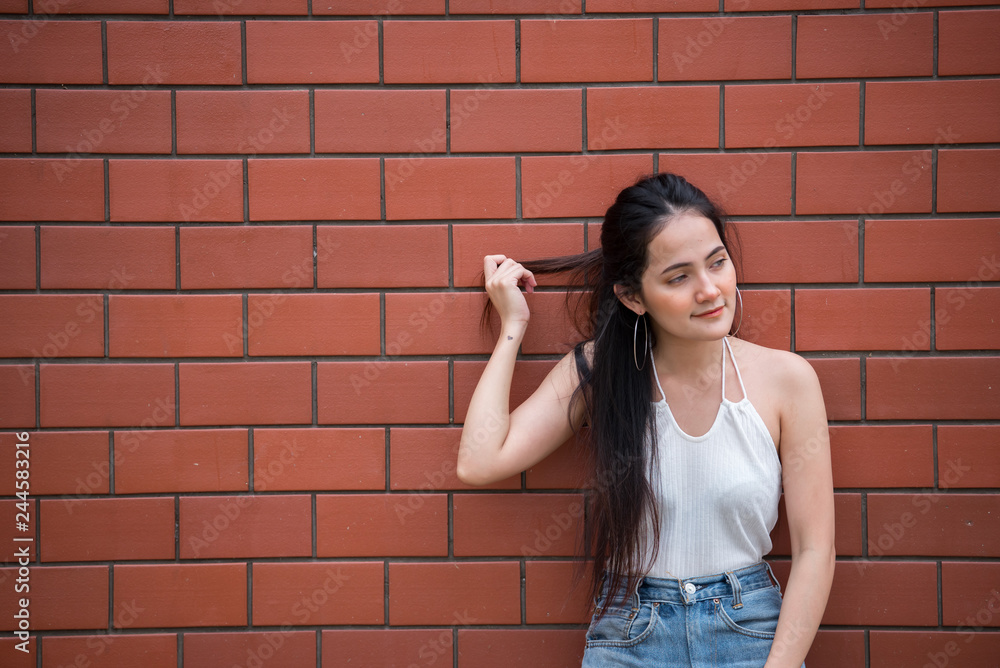 Portrait of beautiful asian chic girl pose for take a picture on wall background,Lifestyle of teen thailand people,Modern woman happy concept Portrait of beautiful asian chic girl pose for take a picture on wall background,Lifestyle of teen thailand people,Modern woman happy concept