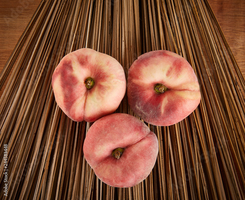 3 Fresh peaches on a wood backdrop