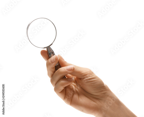 Woman holding magnifying glass on white background, closeup