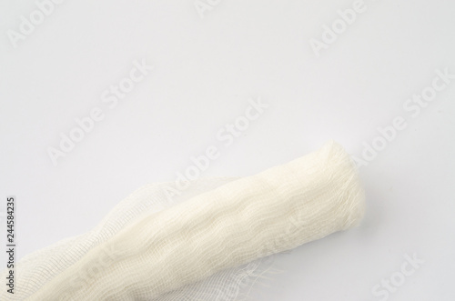 Medical glove and bandage on a white background.