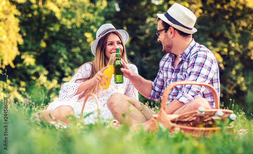 Loving couple enjoying picnic in the park. Love and tenderness, dating, romance, lifestyle concept