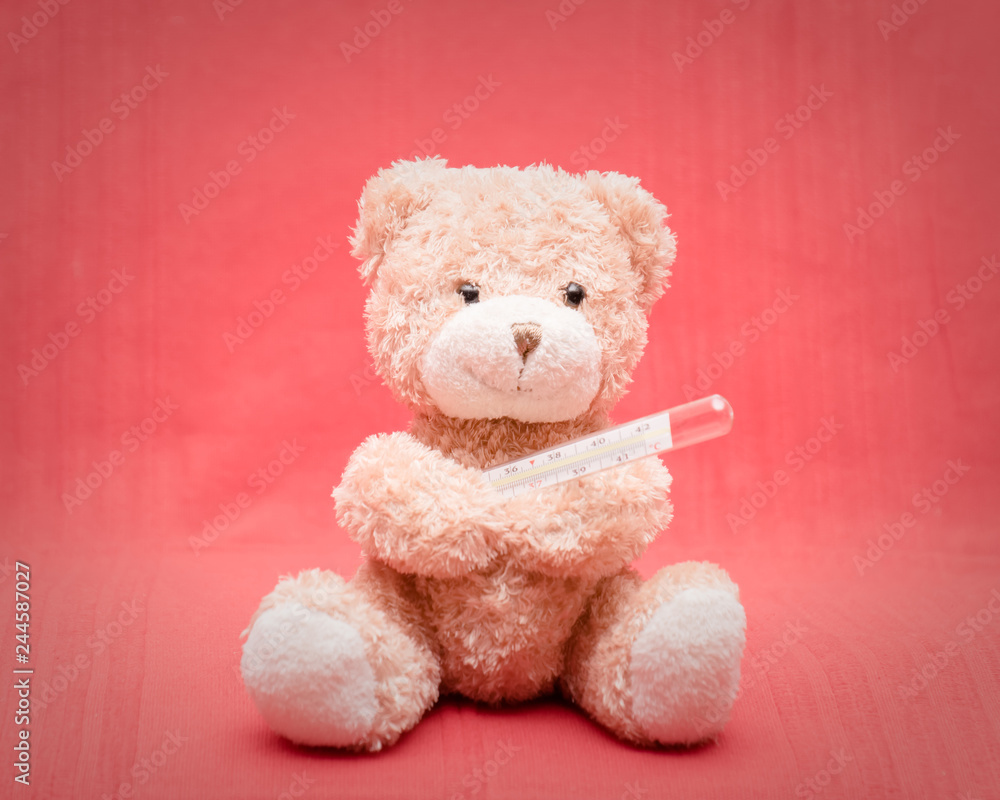 Teddy bear with a mercury thermometer Teddy bear with a mercury thermometer