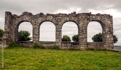 Grasslands in the Basque country with a ancient monument on a cloudy day © Tomas