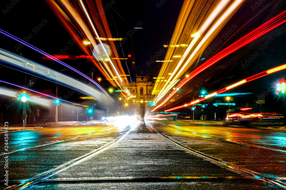 Fototapeta premium Munich, germany - January 20 2019: A long exposure shot of the maximilianstreet in munich, germany, with the lights of the cars and trams and the parliament of bavaria in the back