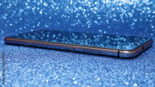 shiny smartphone  on blue Bokeh Effect Backgrounds
