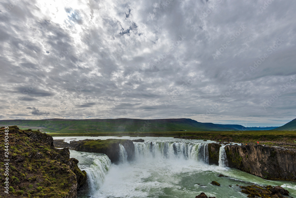 Godafoss waterfall landscape covered with clouds crossed by sunlight. Godafoss waterfall landscape covered with clouds crossed by sunlight.
