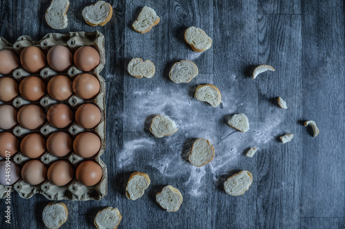 egg carton and bread on wooden background