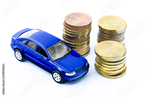 Model of blue car and coins on a white background. Isolated toy car and money. Financial concept. Buy a new or old car.