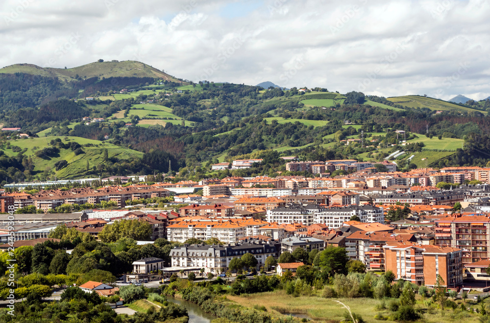 Naklejka premium Zarautz in the Basque Country, Spain, on a sunny day with the mountains in the background