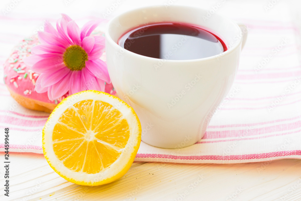 Black tea ceremony - a cup of tea, teapot, sugar, cakes, flowers on white wooden rustic background Black tea ceremony - a cup of tea, teapot, sugar, cakes, flowers on white wooden rustic background
