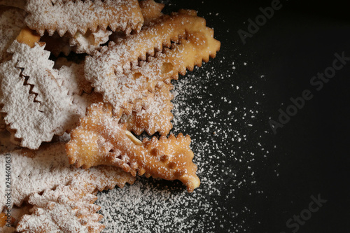 Chiacchiere: dolci tipici italiani di carnevale ricoperte di zucchero a velo photo