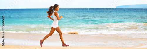 Runner girl training on beach - exercise workout fit Asian woman athlete jogging in sports wear and shoes banner panorama ocean background.