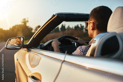 aucasian man driving cabrio in summer photo