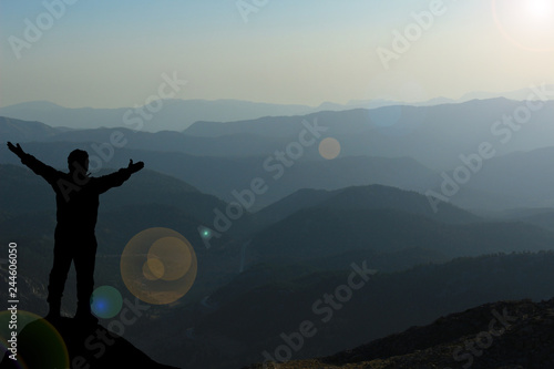 man breathing at mountain peak