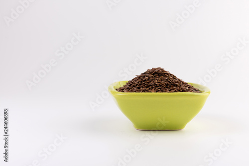 Flax seeds in bowl isolated on white background