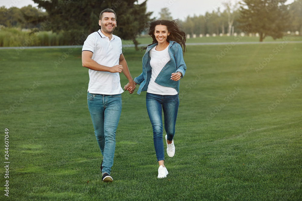 couple running in the park at daytime