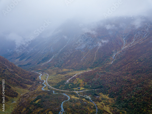Drone Photo of Several Small Waterfalls in Mountains with Clouds Covering them Near Bøjabreen Glacier in Norway