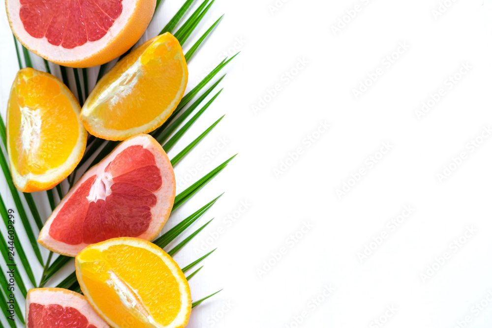 The basis for the banner with palm leaf and fruit. Grepfruit, orange, palm leaf with space for copispeysa. Frame for text with leaf of palm tree and fruit on a wooden background The basis for the banner with palm leaf and fruit. Grepfruit, orange, palm leaf with space for copispeysa. Frame for text with leaf of palm tree and fruit on a wooden background
