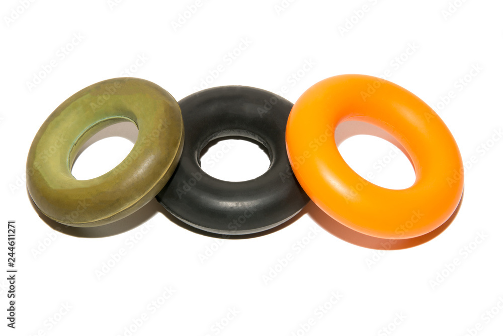 Means to strengthen the muscles of the hand. Expanders with different loads. Strength training. Multicolored expanders. Isolated on white background. Means to strengthen the muscles of the hand. Expanders with different loads. Strength training. Multicolored expanders. Isolated on white background.