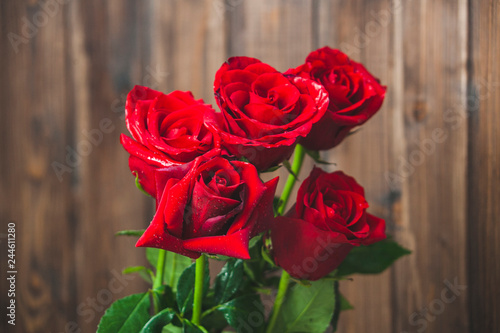 Red roses bouquet on brown background