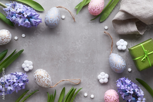 Easter flat lay with blue hyacinth flowers, easter eggs and large heart on light background
