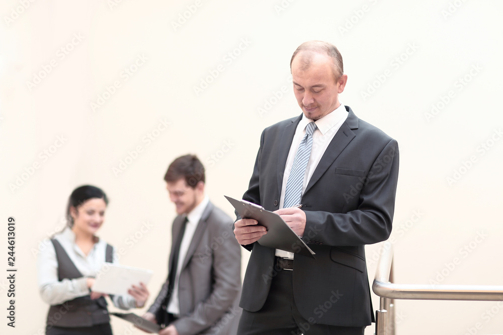 close up. businessman taking notes in clipboard