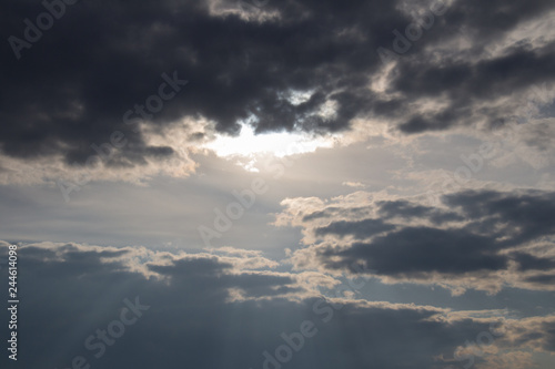 Sun lights coming through clouds. Skyscape at sunset. © daisy_y