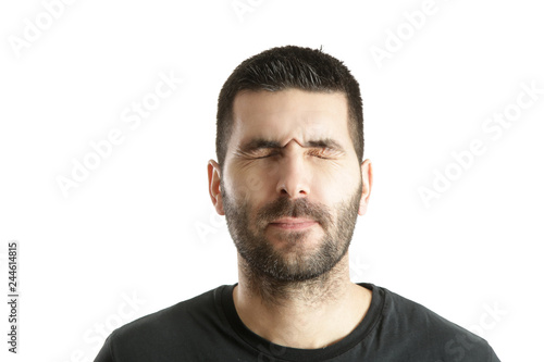 Studio shot of a young bearded man making a facial expression