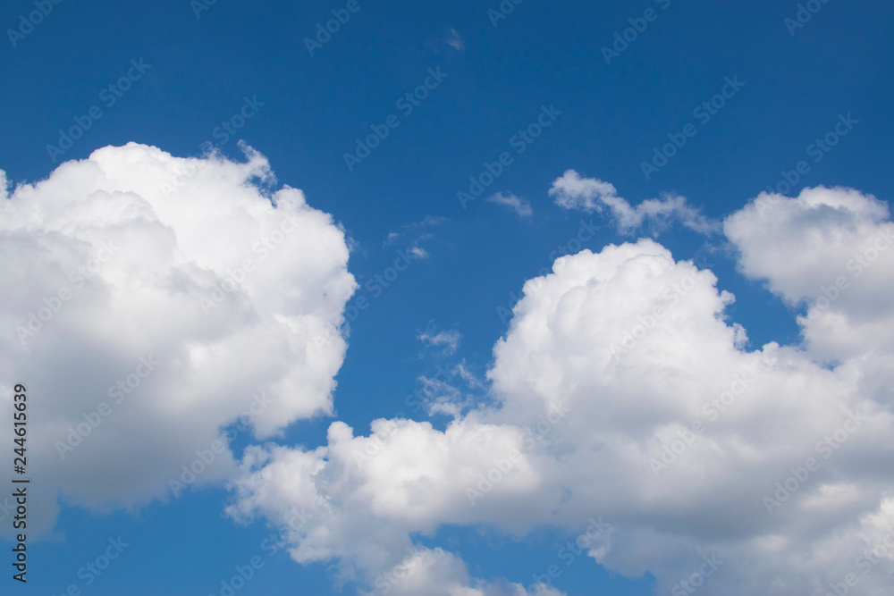 Fantastic panorama view of bright white puffy cottony clouds lit by sun spreading against deep blue summer sky moving with wind. Beauty and power of nature, meteorology and climate changing concept. Fantastic panorama view of bright white puffy cottony clouds lit by sun spreading against deep blue summer sky moving with wind. Beauty and power of nature, meteorology and climate changing concept.