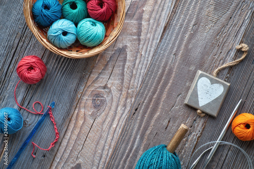 Crochet, top view on yarn balls on rustic wood