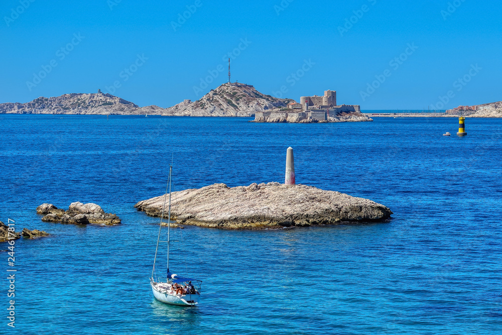 Boat sails to castle If (chateau d If) from Notre-Dame de la Garde, Marseille, France