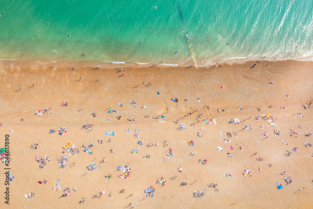 Aerial view of seaside with people sunbathing Aerial view of seaside with people sunbathing