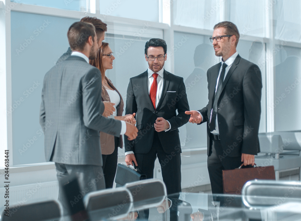 employees talking standing in the office employees talking standing in the office