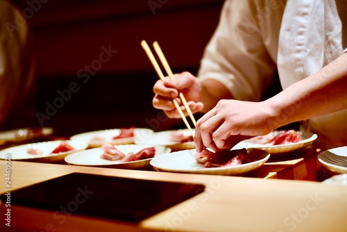 Master sushi chef preparing omakase tasting course in Tokyo, Japan