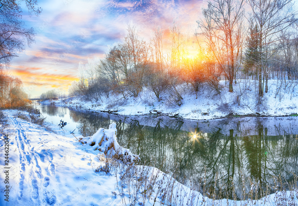Winter landscape by a river in the sunset Winter landscape by a river in the sunset