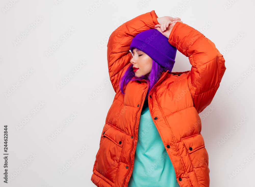 Beautiful young girl with purple hair and in orange jacket on white background. Beautiful young girl with purple hair and in orange jacket on white background.
