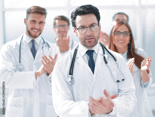 successful doctor  accepting congratulations from colleagues