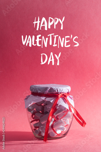 Happy valentine's day. Glass jar, full of rolled papers with sweet dreams photo