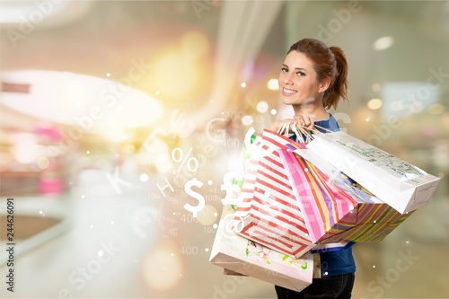 Young woman with shopping bags on blurred shopping mall