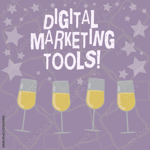 Writing note showing Digital Marketing Tools. Business photo showcasing Channels or platforms use in advertising a product Filled Cocktail Wine Glasses with Scattered Stars as Confetti Stemware