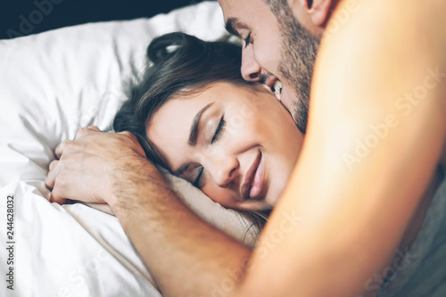 Fotografie Happy romantic couple having a tender moment in the bed - Young passionate lover