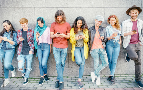 Group of fashion friends watching on their smart mobile phones - Millennial generation z addicted to new technology trends - Concept of people, tech, social media, friendship and youth lifestyle