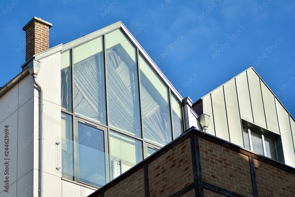 Fototapeta premium Modern apartment buildings on a sunny day with a blue sky. Facade of a modern apartment building