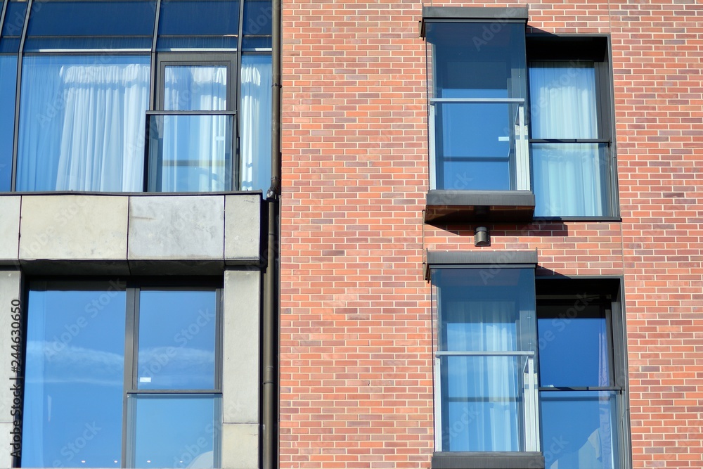 Modern apartment buildings on a sunny day with a blue sky. Facade of a modern apartment building Modern apartment buildings on a sunny day with a blue sky. Facade of a modern apartment building