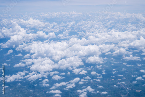 Sky scape cloudscape from aerial airplane shot of blue clouds. View flying above moutain from windows over Loei, Thailand.