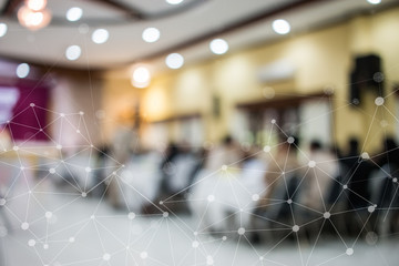 Blurred of speaker on stage IOT network, rear view group audience listens speech lecturer in conference hall or seminar at hotel, business and education meeting concept