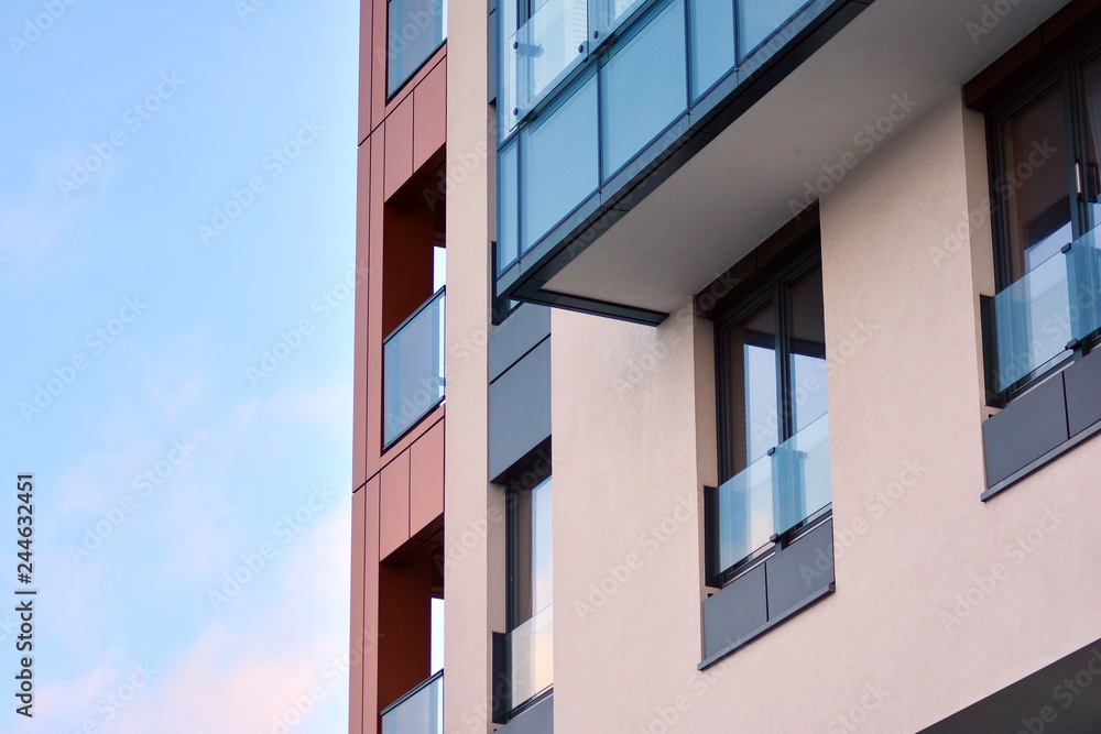 Modern apartment buildings on a sunny day with a blue sky. Facade of a modern apartment building Modern apartment buildings on a sunny day with a blue sky. Facade of a modern apartment building